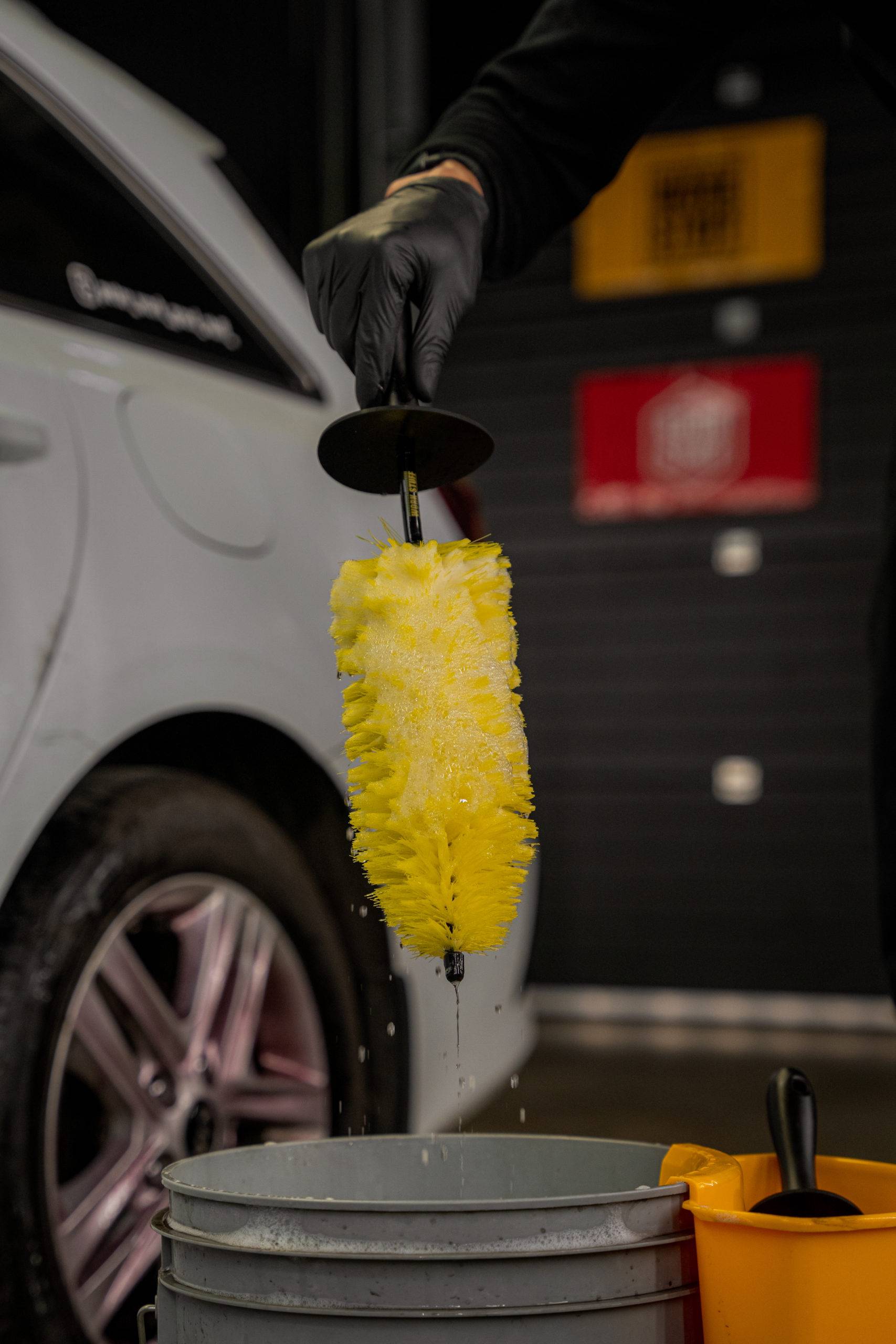 BLIZZARD wheel brush dipped into a soapy detailing bucket