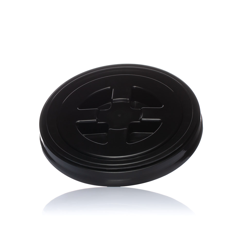 Black, round HDPE bucket lid with raised grooves and circular pattern on white background, slight reflection below.