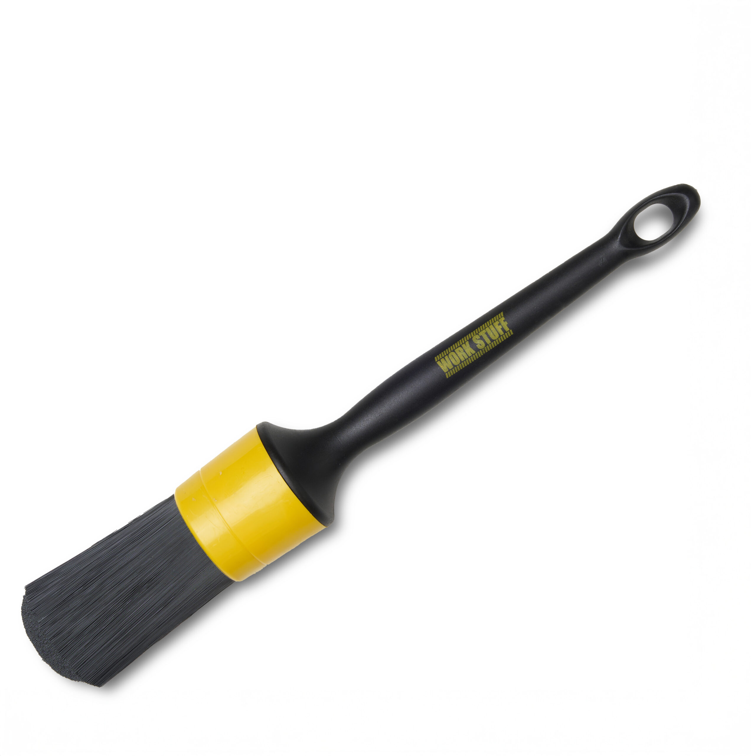 Black detailing brush with stiff bristles, yellow band near base, and hanging hole at handle end on white background.