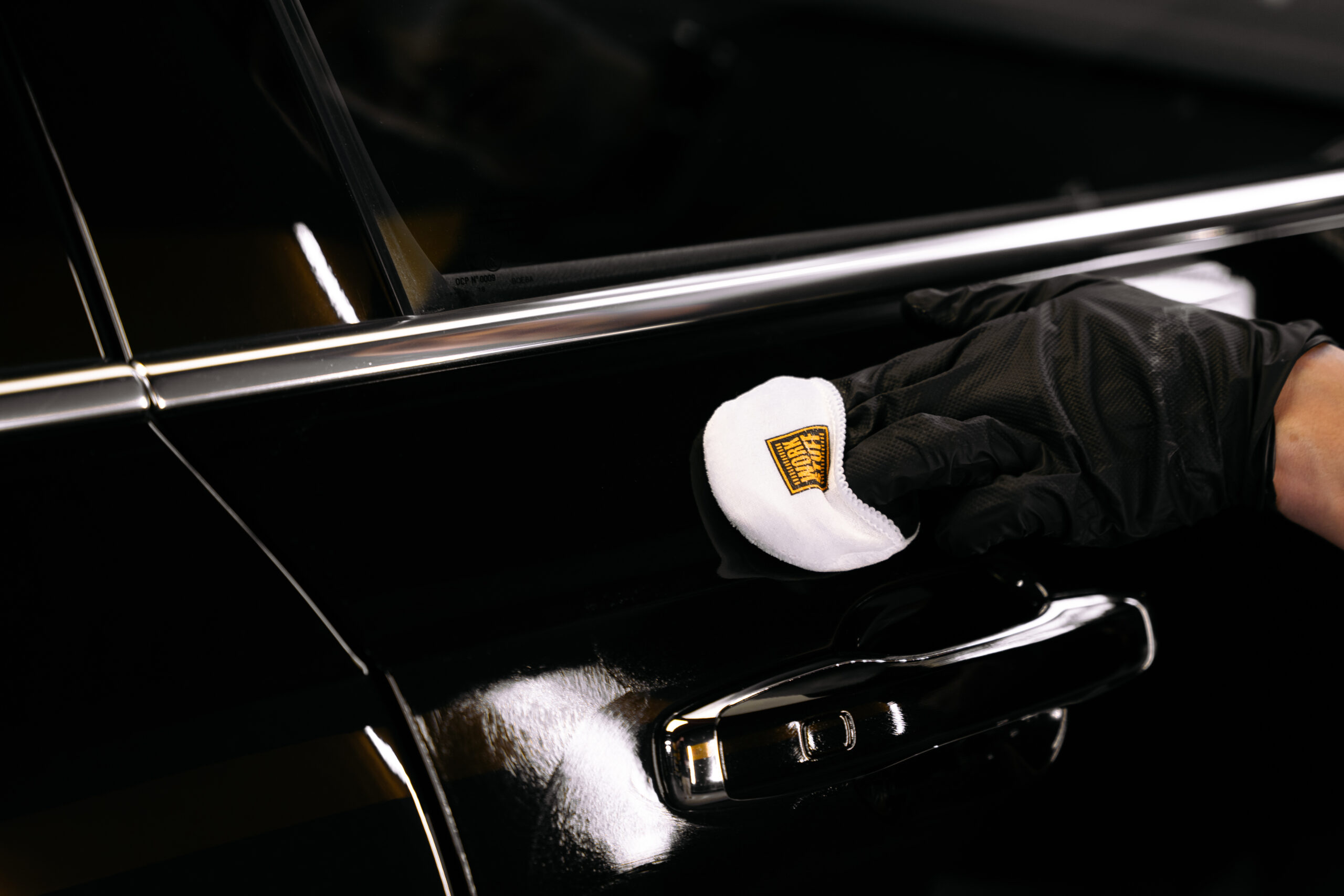Applying ceramic coating to black car paint in controlled passes
