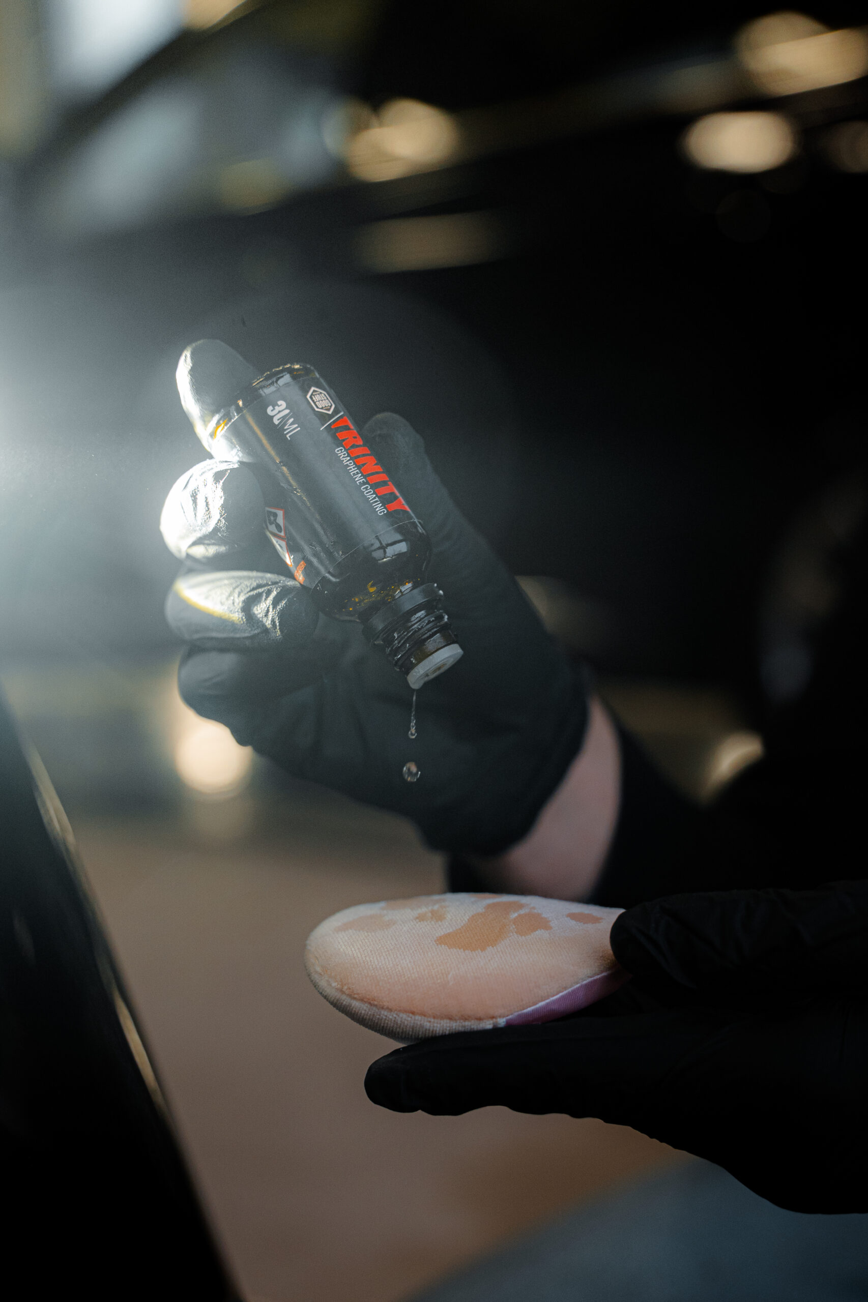 Trinity graphene coating drops being applied to a microfiber applicator pad